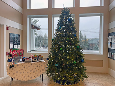 Table of Warm Clothing Next to a Christmas Tree