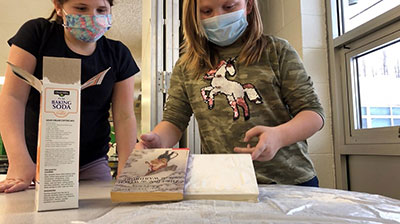 Elementary Students looking at books