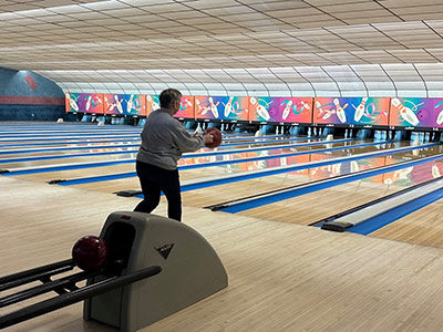 Lena Throwing a Bowling Ball Down a Lane