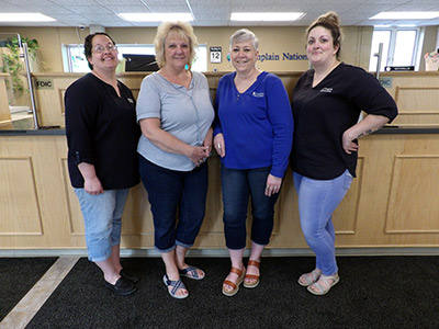 Group of Women Wearing Jeans Standing in Front of the Teller Line