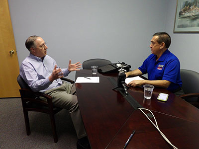 Steven Cacchio and Ernie Galarza Speaking into a Microphone