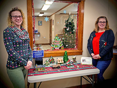 Two People Wearing Holiday Sweaters